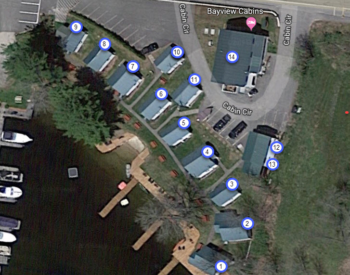 birds eye view of cabins arranged by lake with labels showing number and capacity