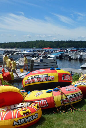 bright orange and yellow water tubes and lots of motorboats at the local marina